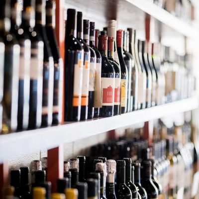 a row of wine glasses on a shelf