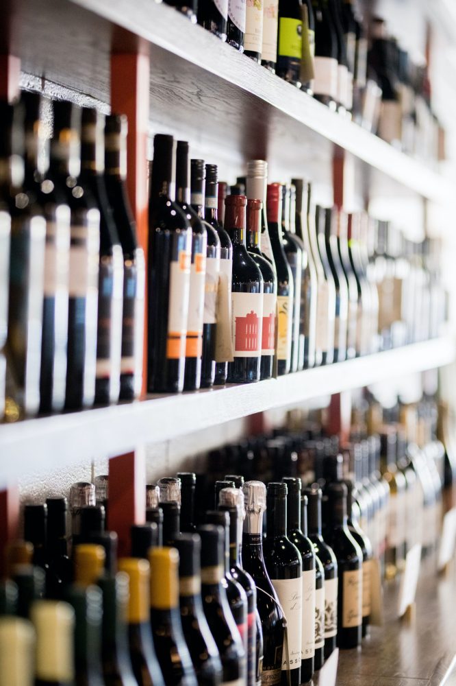 a row of wine glasses on a shelf