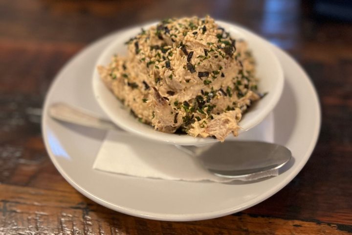 a plate with a piece of cake sitting on top of a wooden table